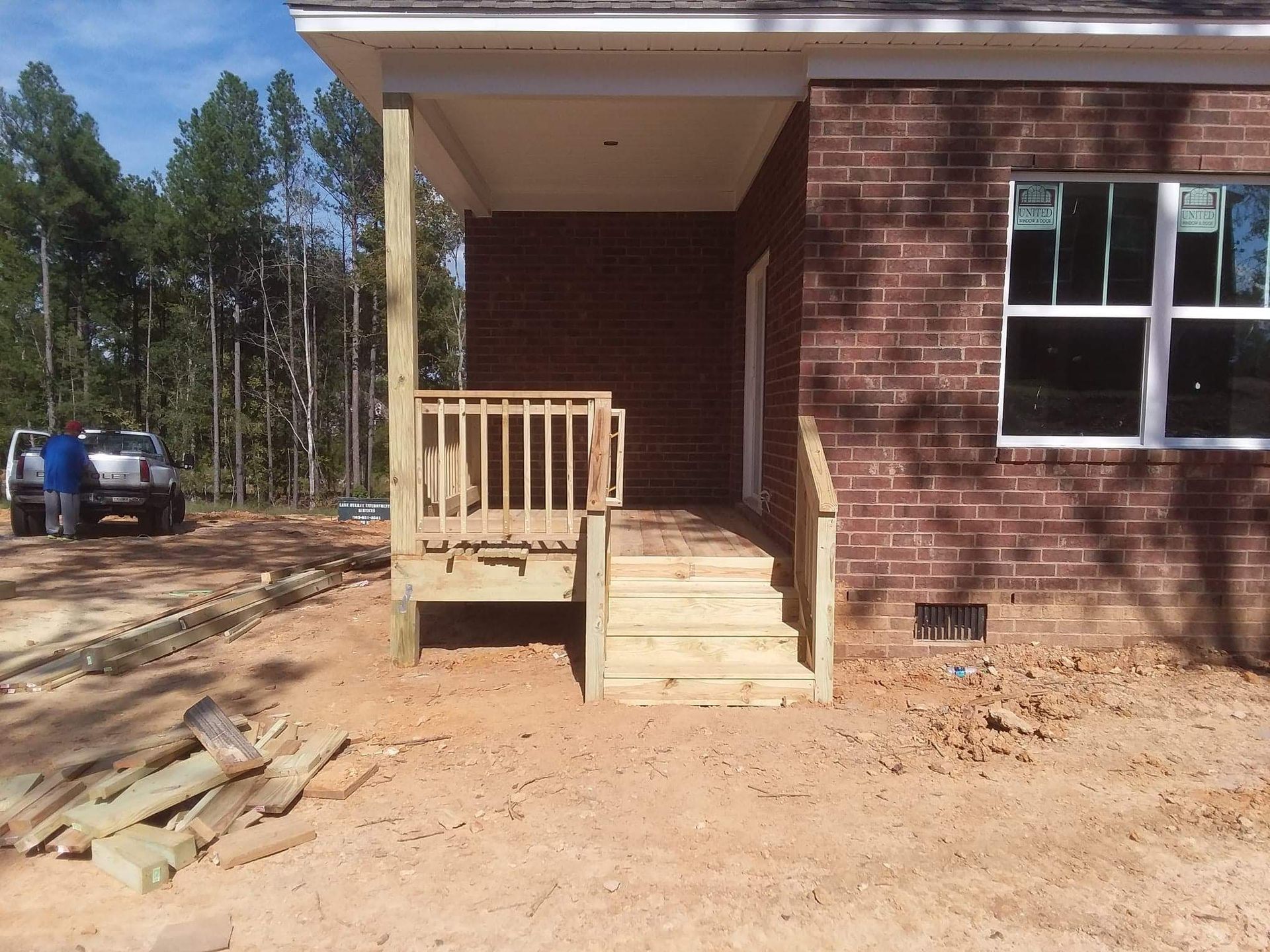 A brick house with a wooden deck in front of it