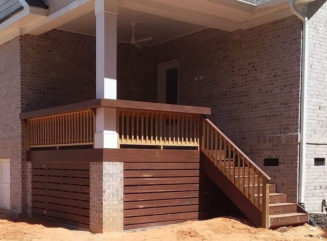 A wooden deck with stairs leading up to it