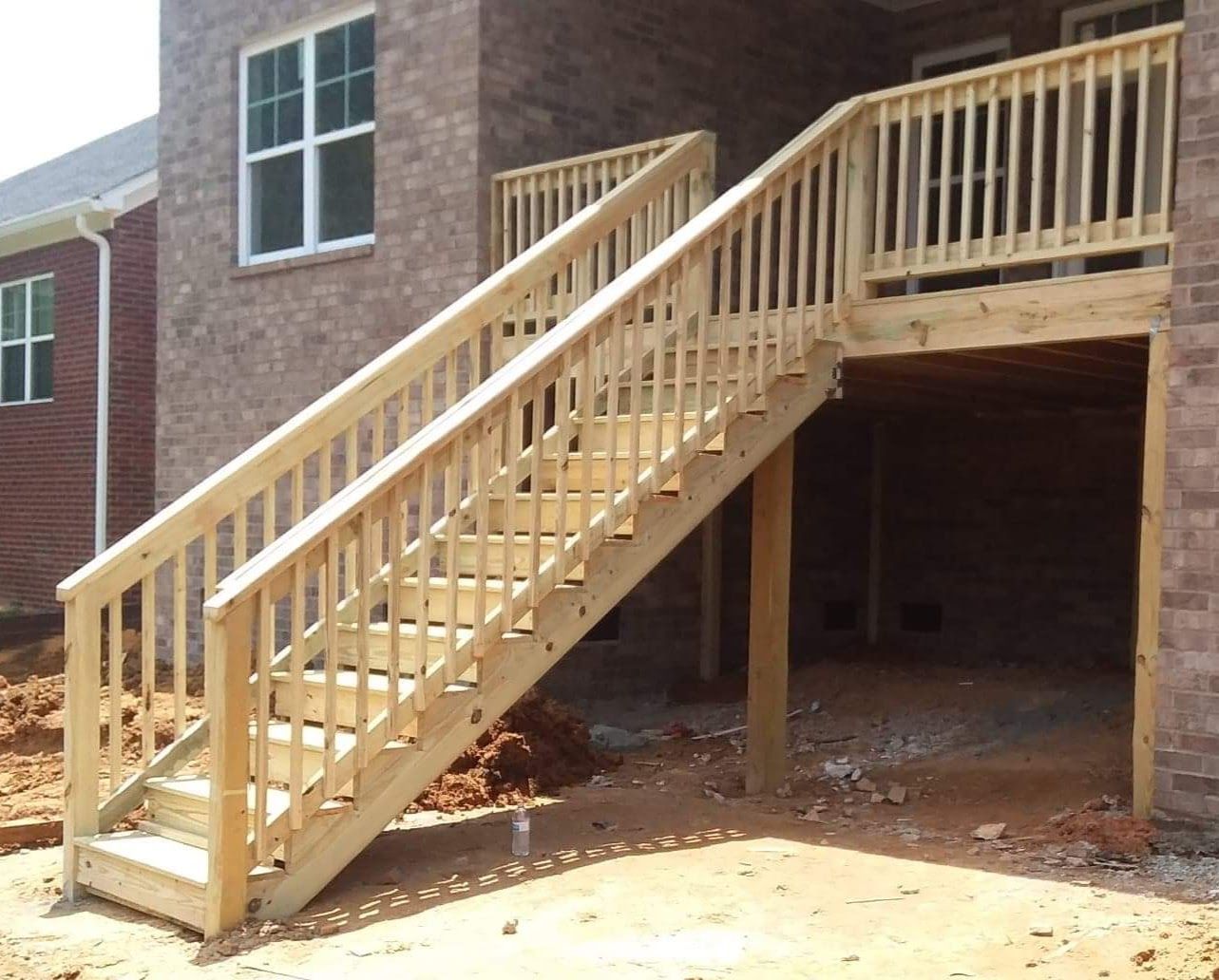 A wooden deck with stairs leading up to it