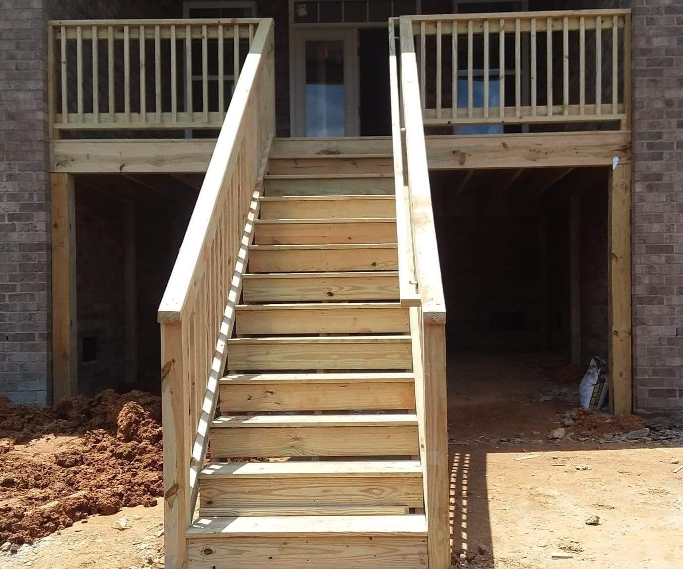 A wooden deck with stairs leading up to it