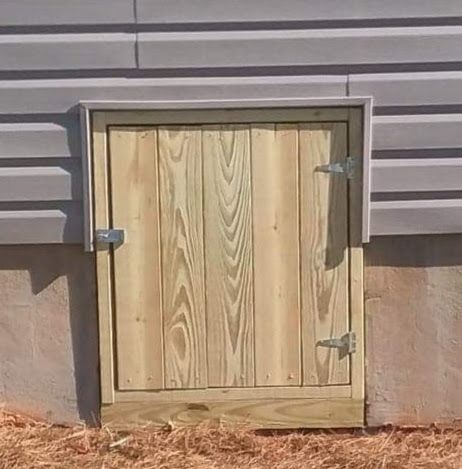 A wooden door is attached to the side of a building.
