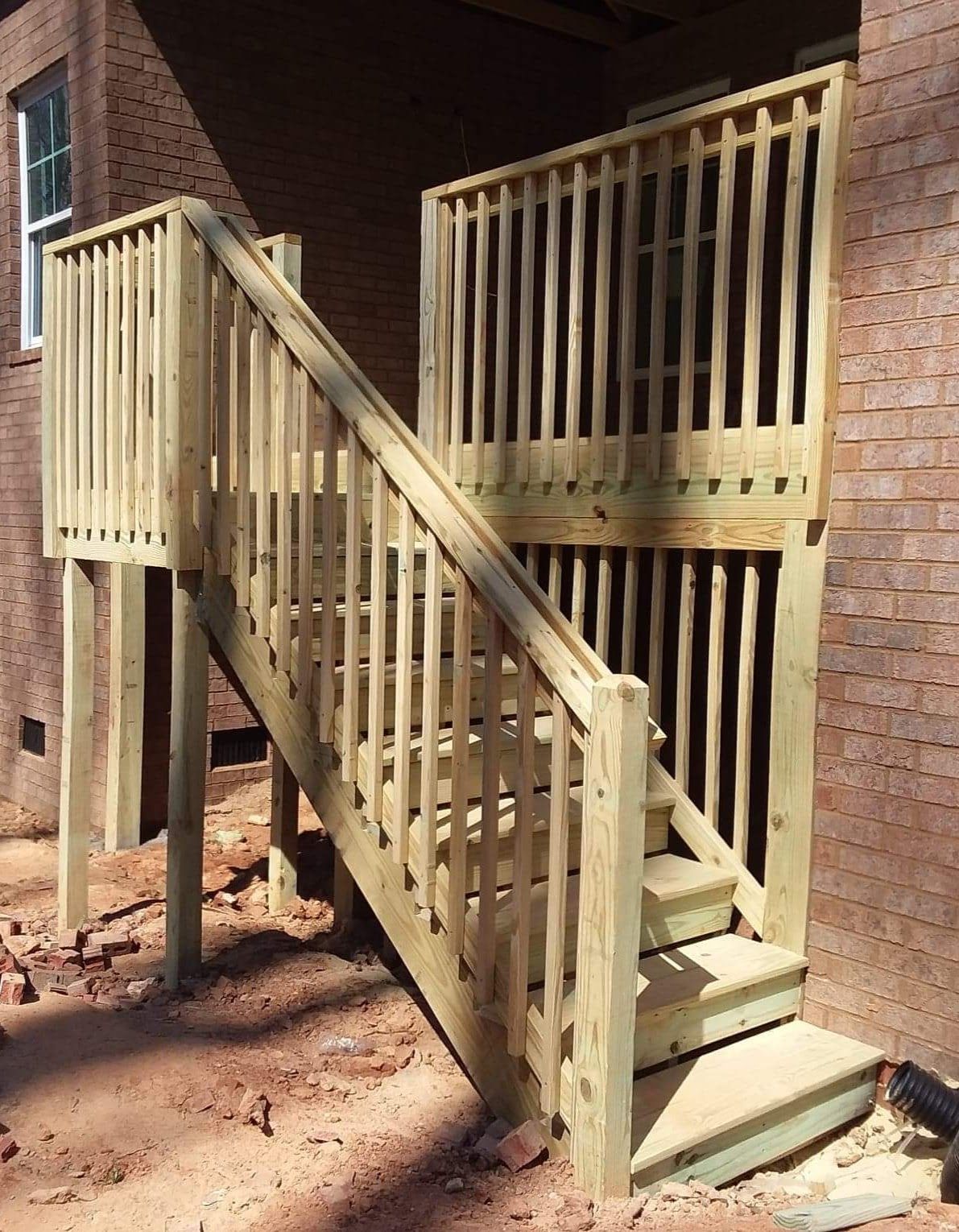 A wooden deck with stairs leading up to it