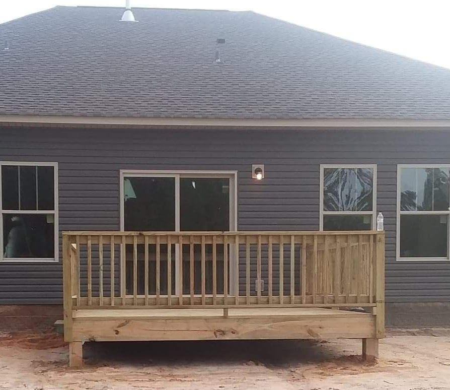 A house with a wooden deck in front of it