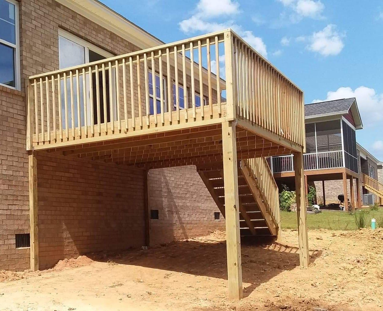 A wooden deck with stairs leading up to it