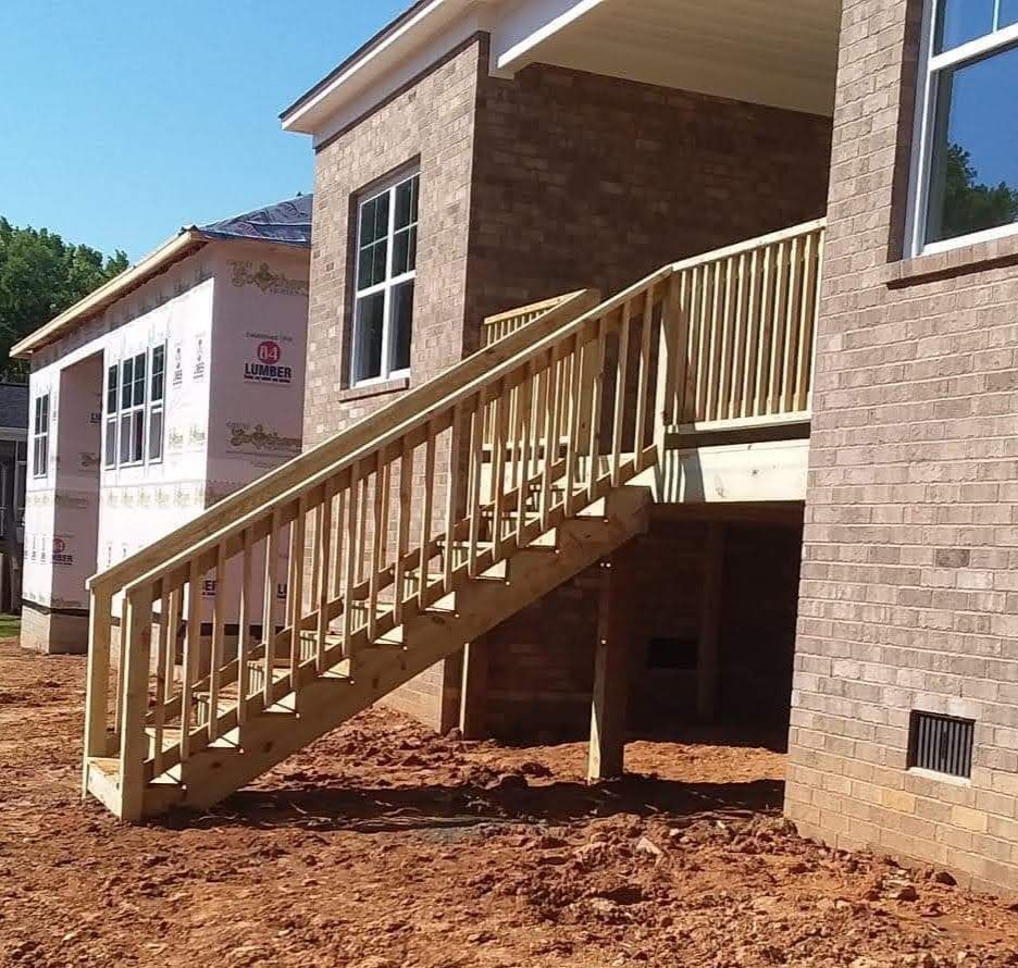 A brick building with a wooden staircase leading up to it