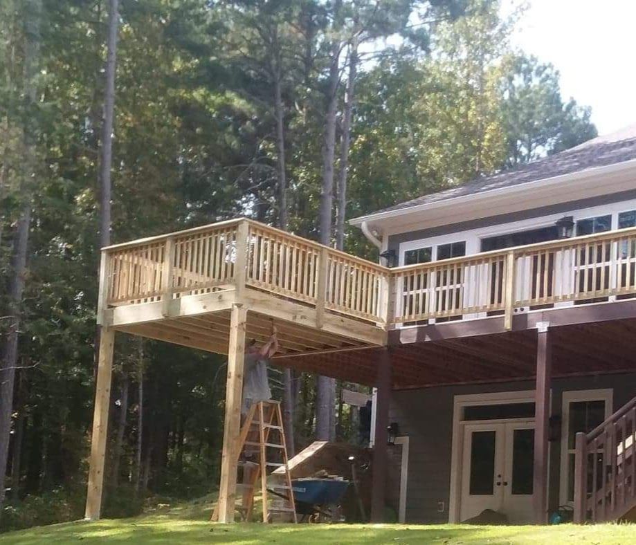 A house with a large wooden deck in front of it