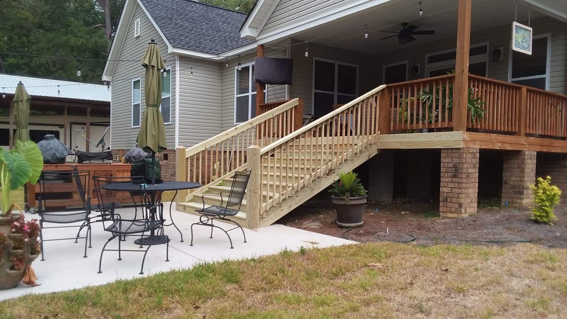A house with a large deck and stairs leading up to it