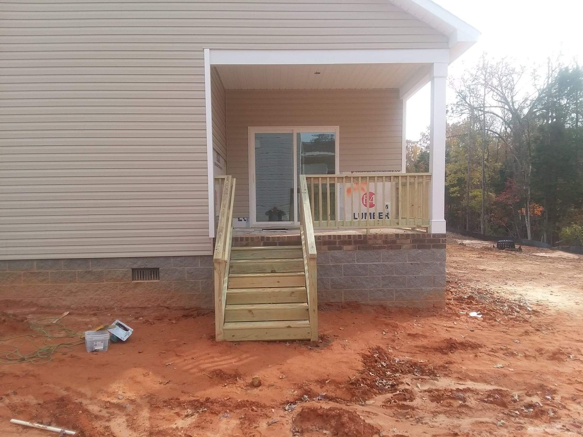 A house with a porch and stairs is for sale