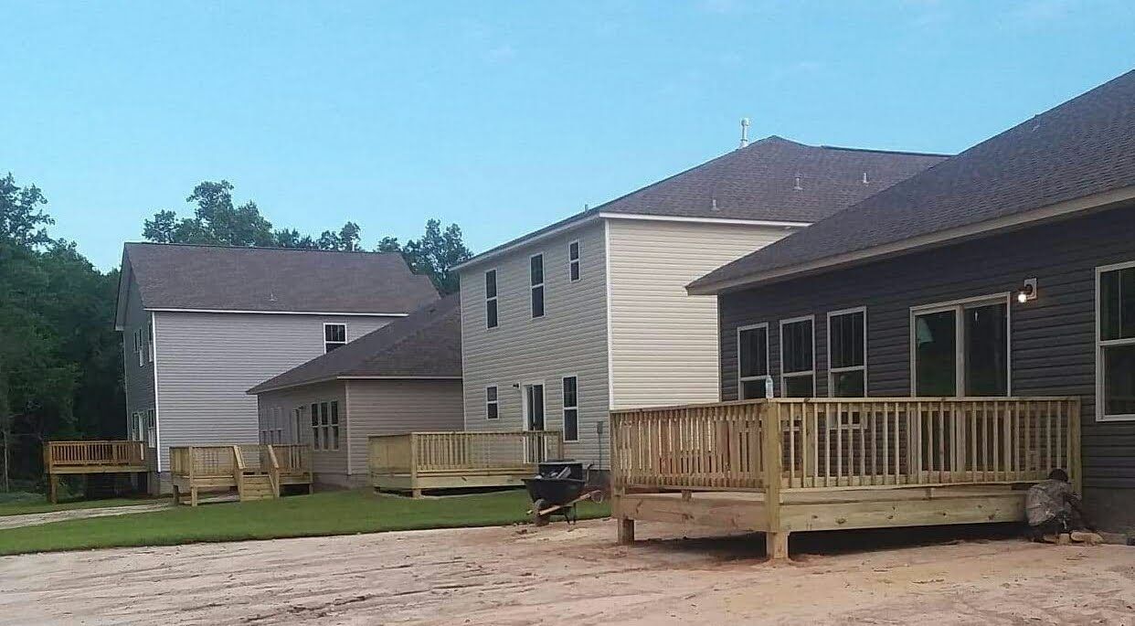 A row of houses with wooden decks in front of them