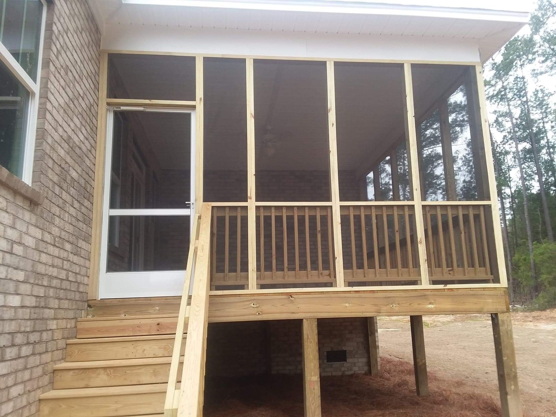 A screened in porch with stairs leading up to it