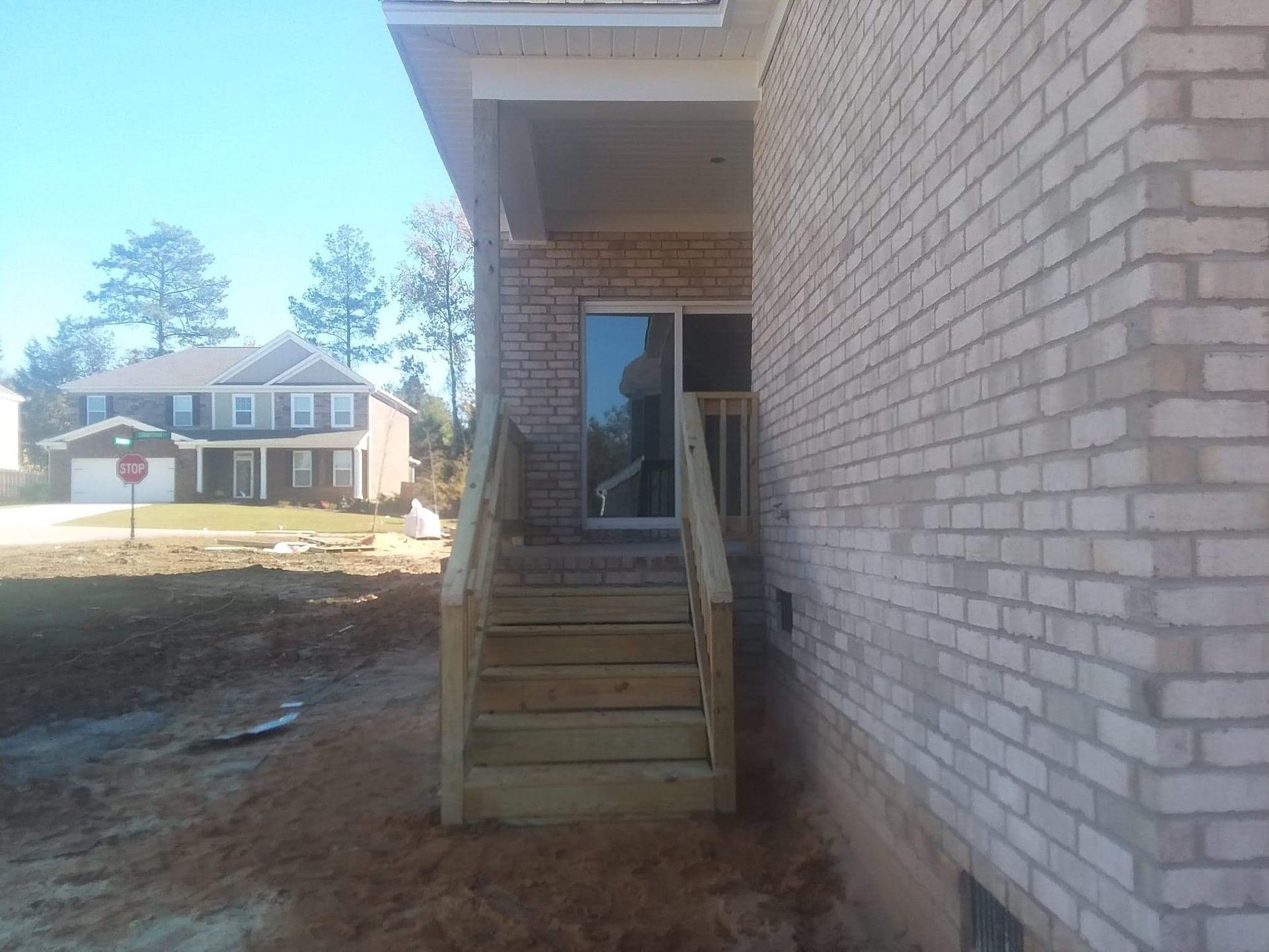 A brick building with wooden stairs leading up to it