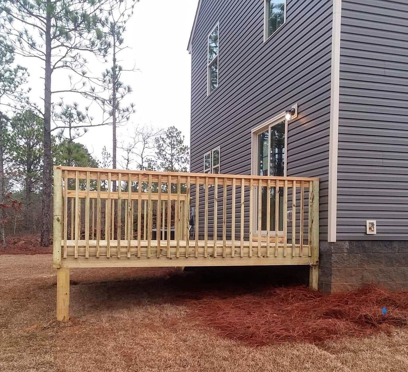 A large house with a wooden deck in front of it