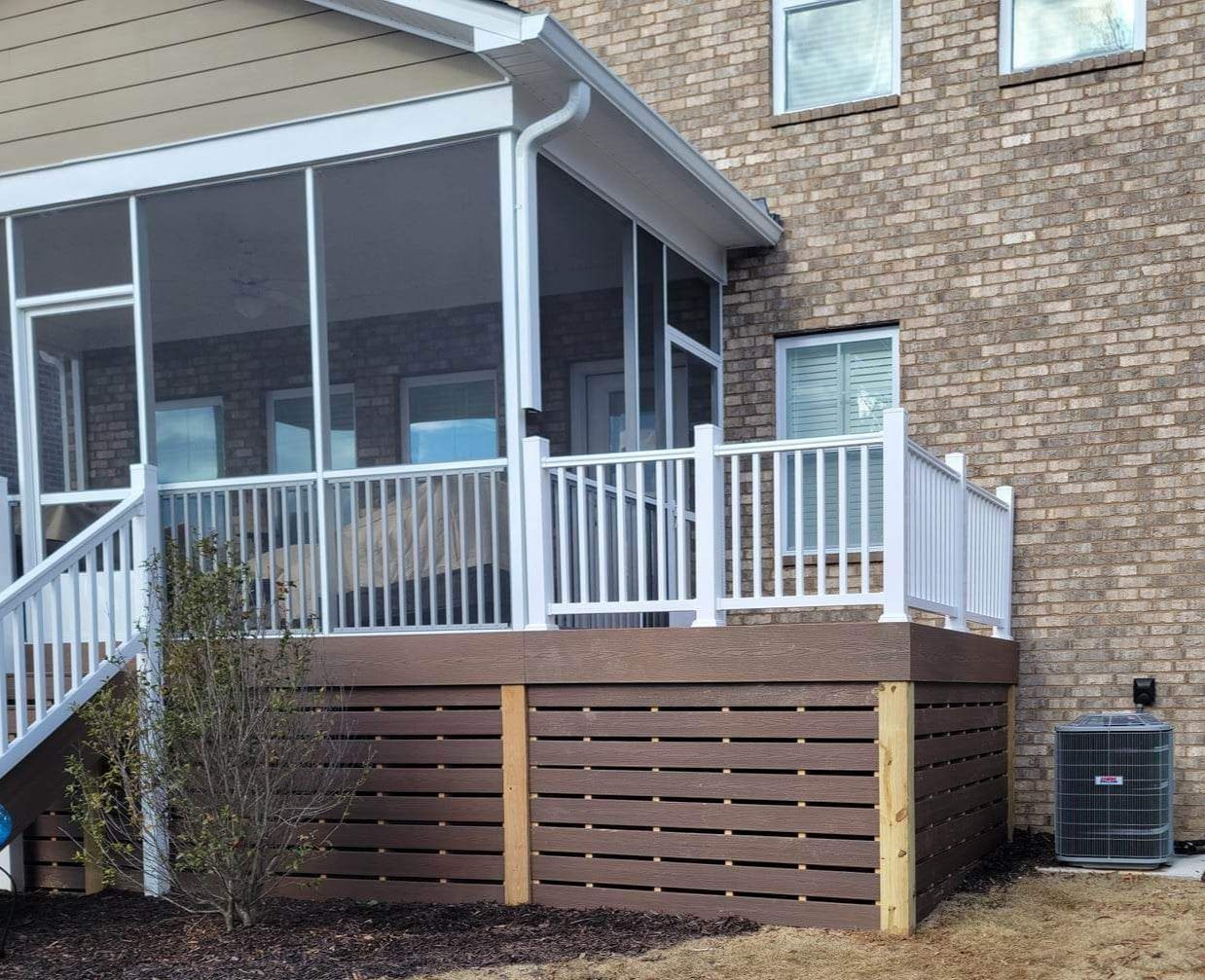 A house with a screened in porch and stairs