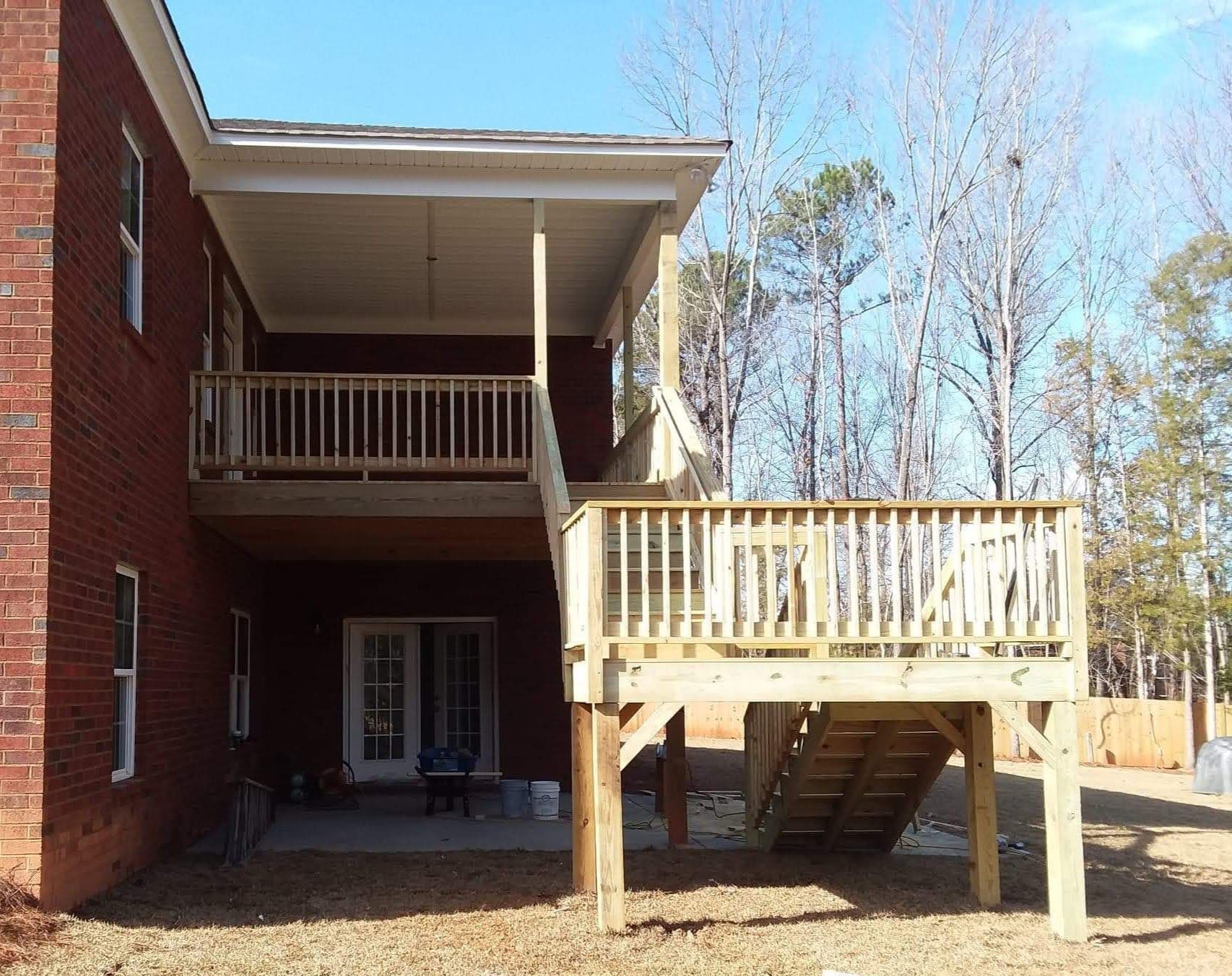A brick house with a wooden deck in front of it