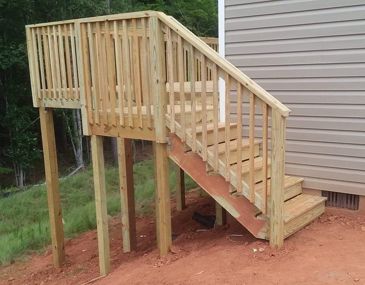 A wooden deck with stairs leading up to it