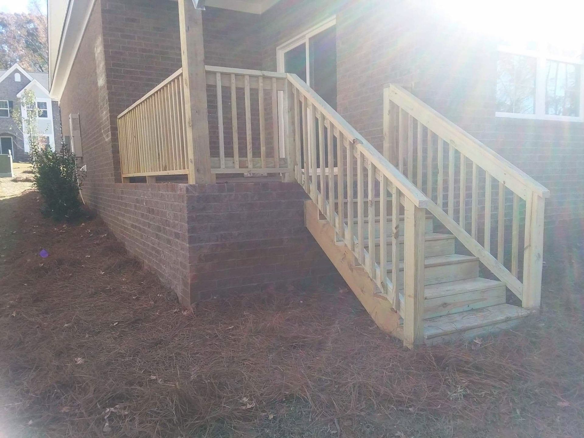 A wooden deck with stairs leading up to it