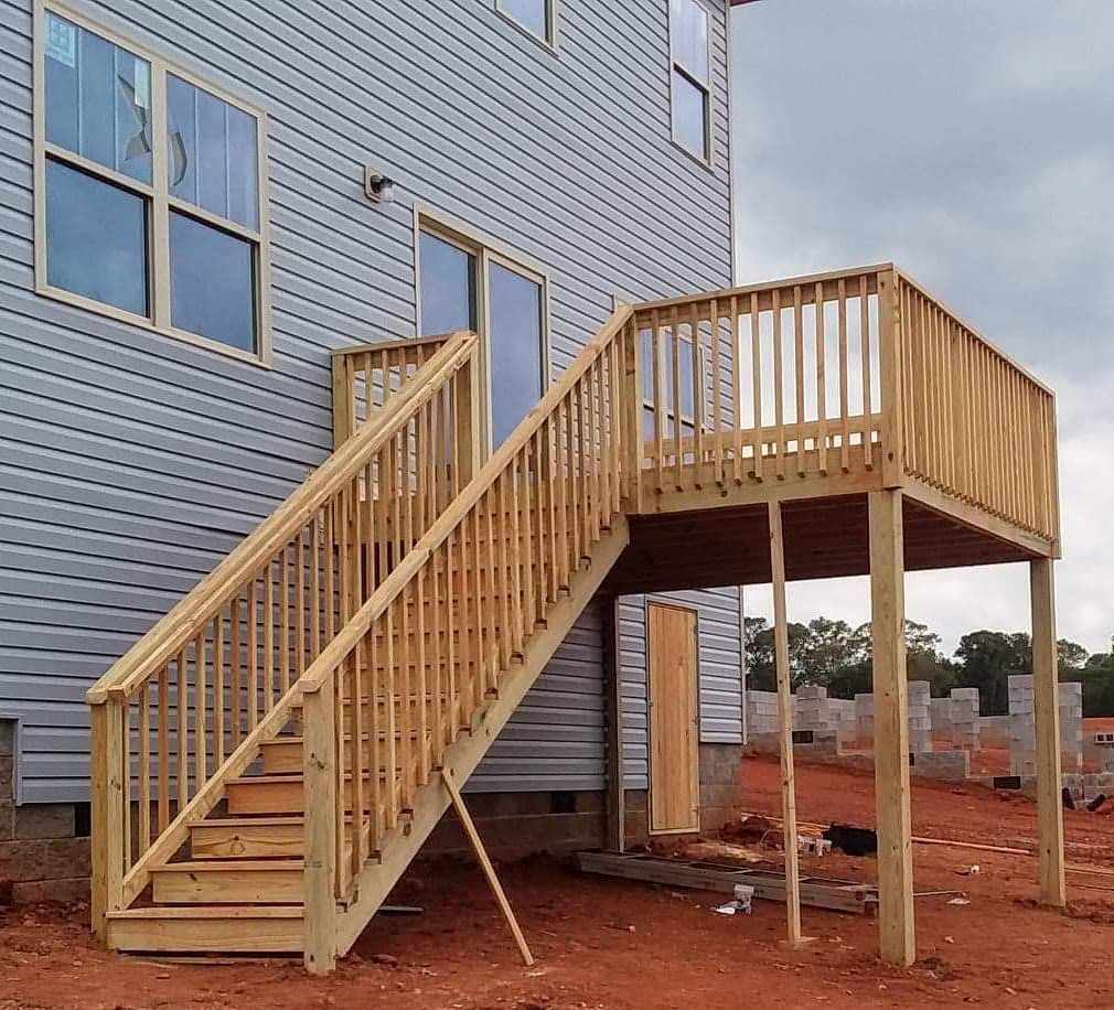 A wooden deck with stairs leading up to it