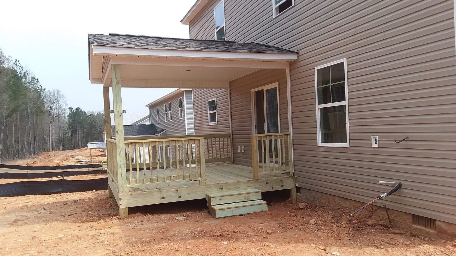 A house with a wooden deck in front of it