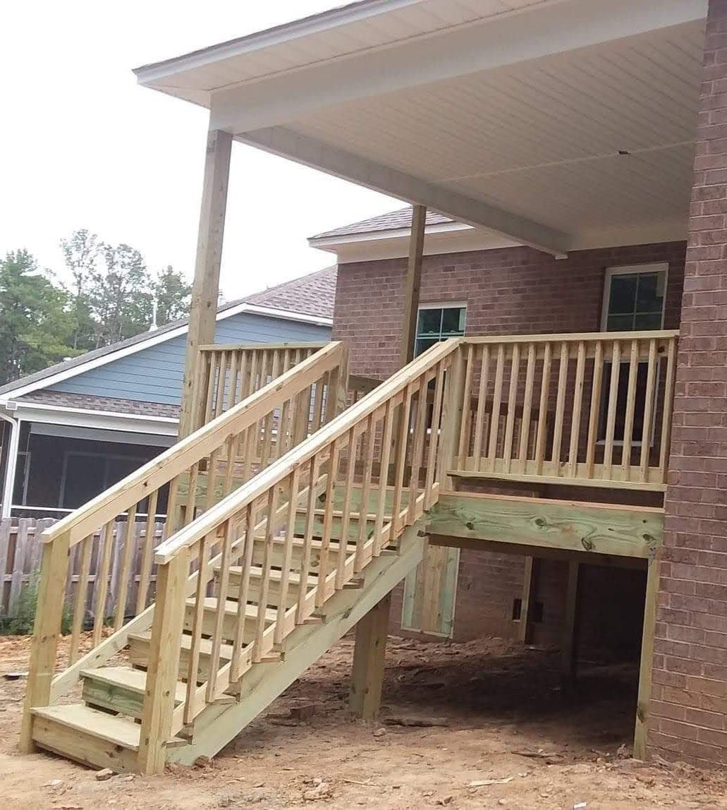 A wooden deck with stairs leading up to it