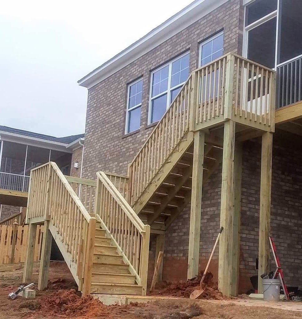 A brick building with wooden stairs leading up to it