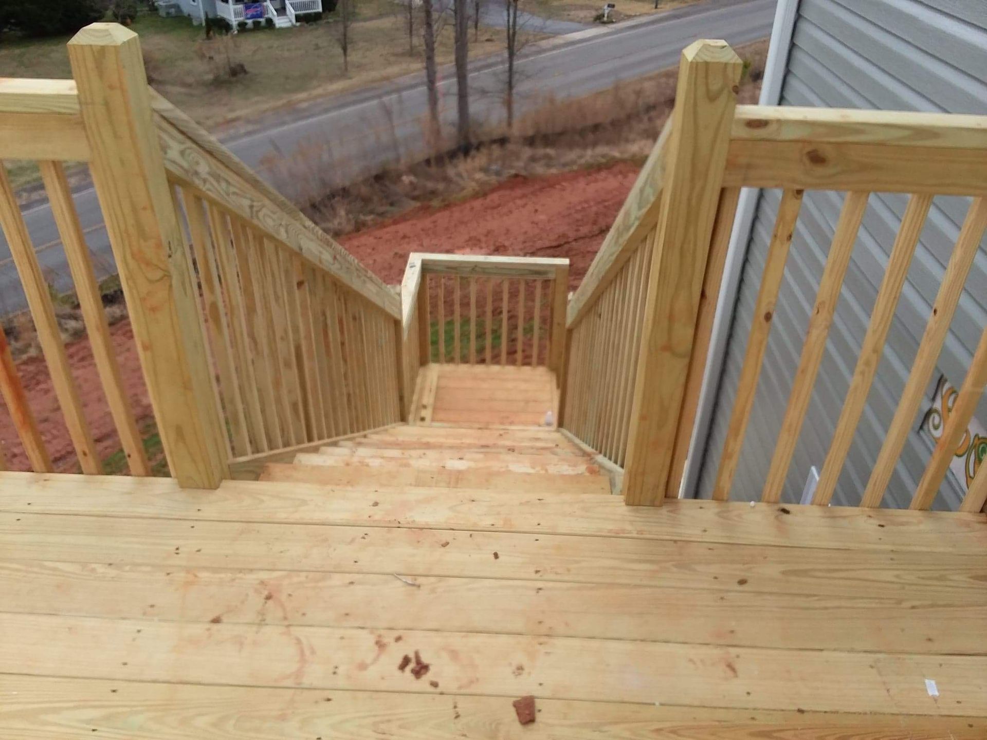 A wooden deck with stairs leading up to it