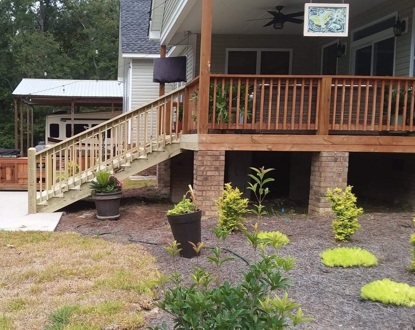 A house with a wooden deck and stairs leading up to it