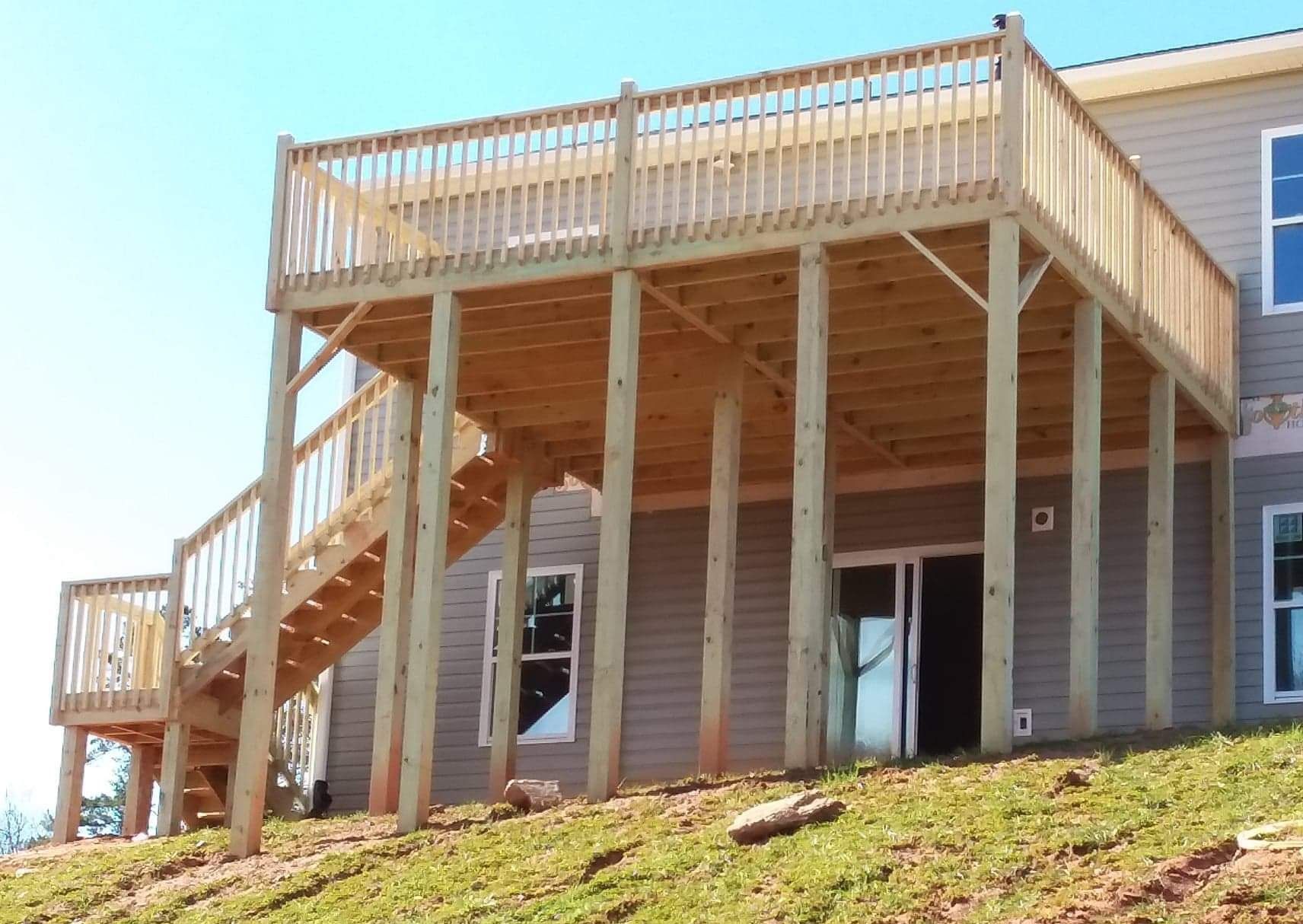 A house with a large wooden deck and stairs