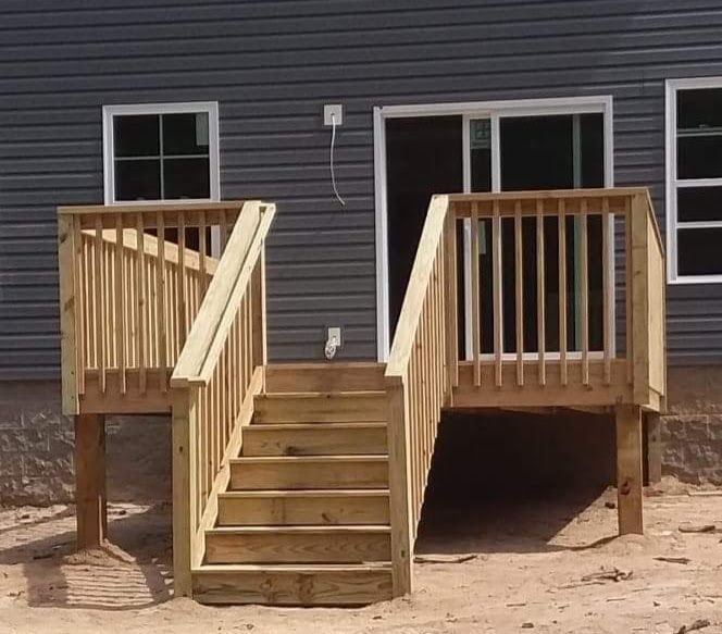 A wooden deck with stairs in front of a house