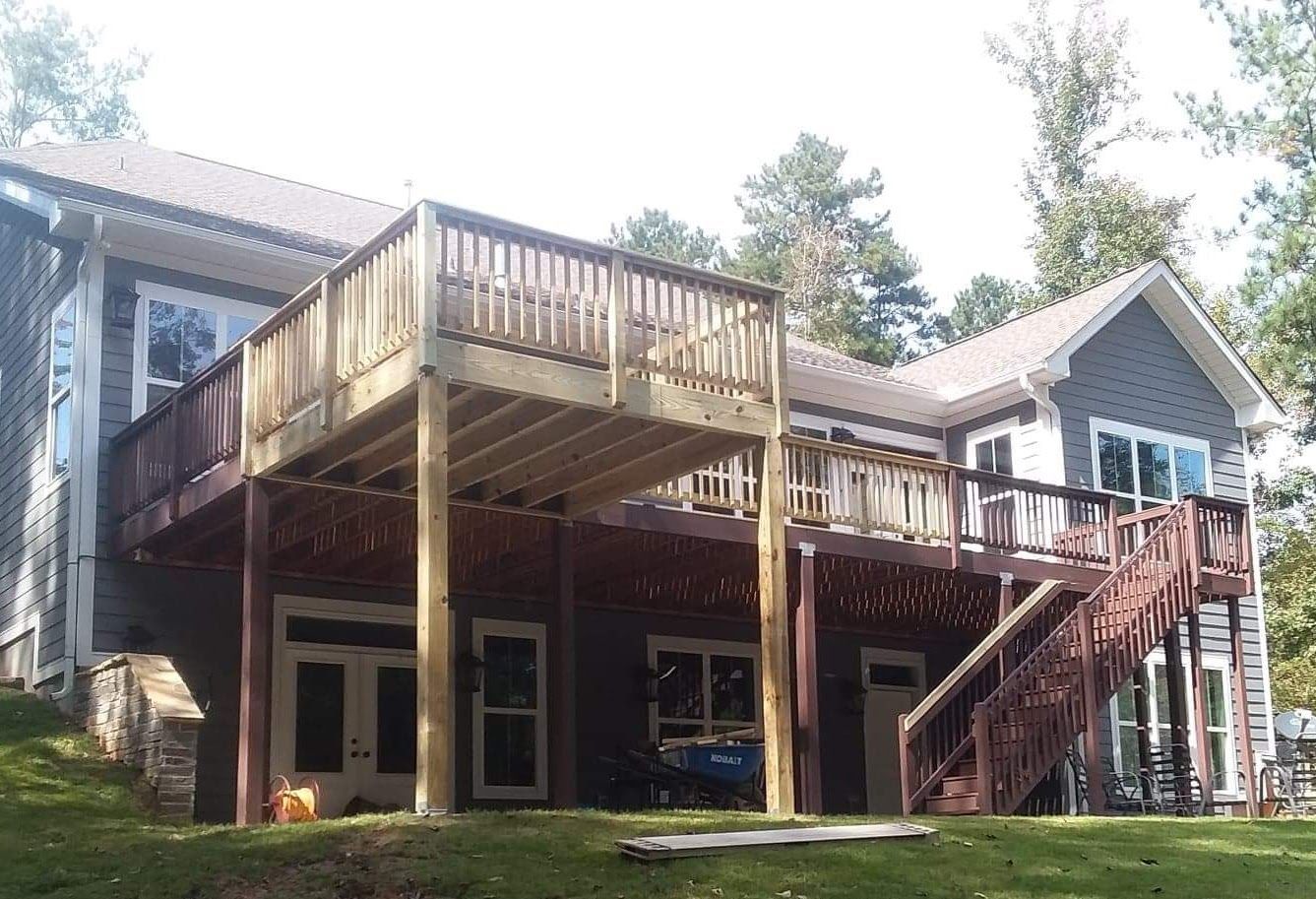 A large house with a large deck on top of it