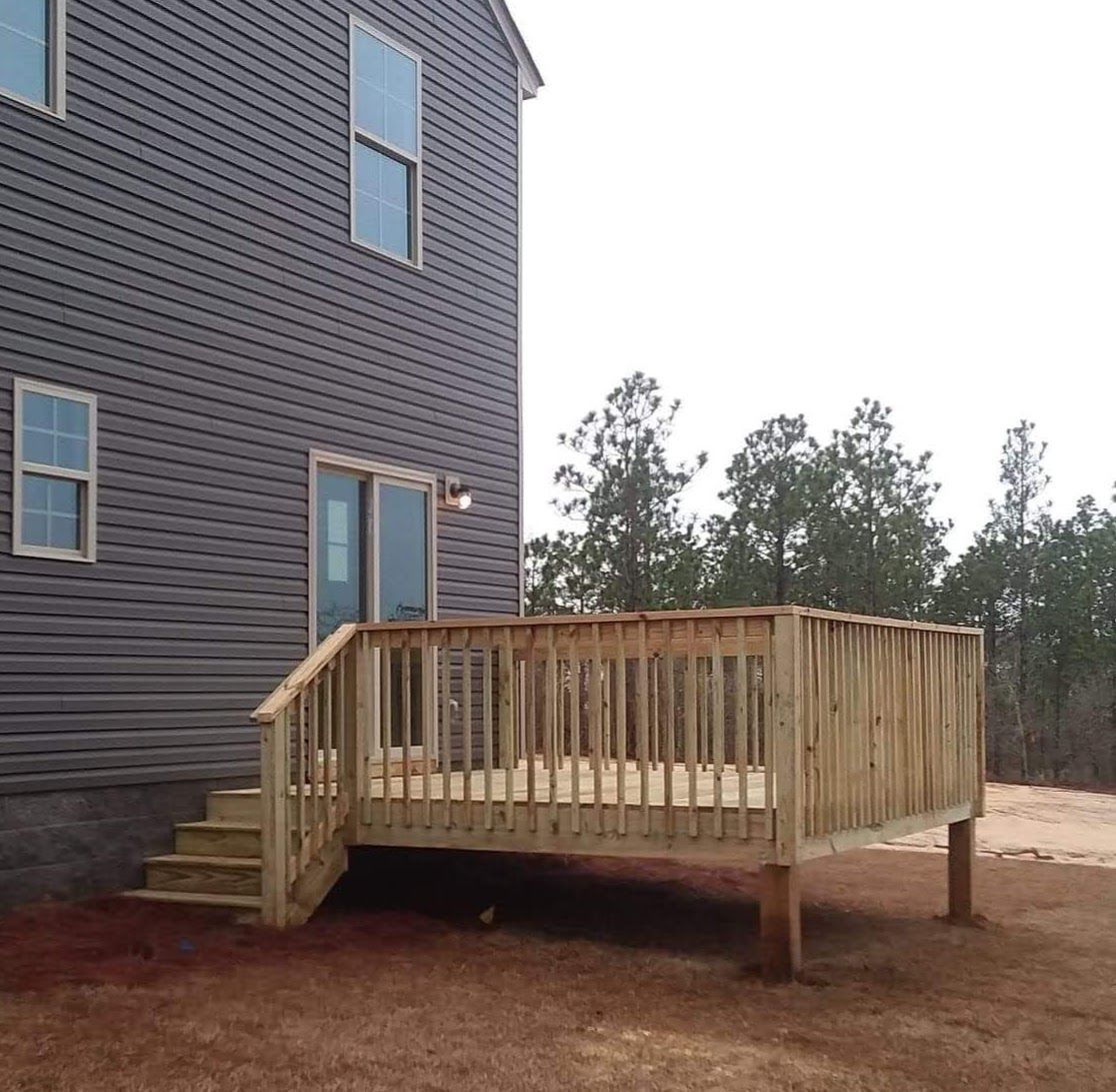A house with a wooden deck in front of it