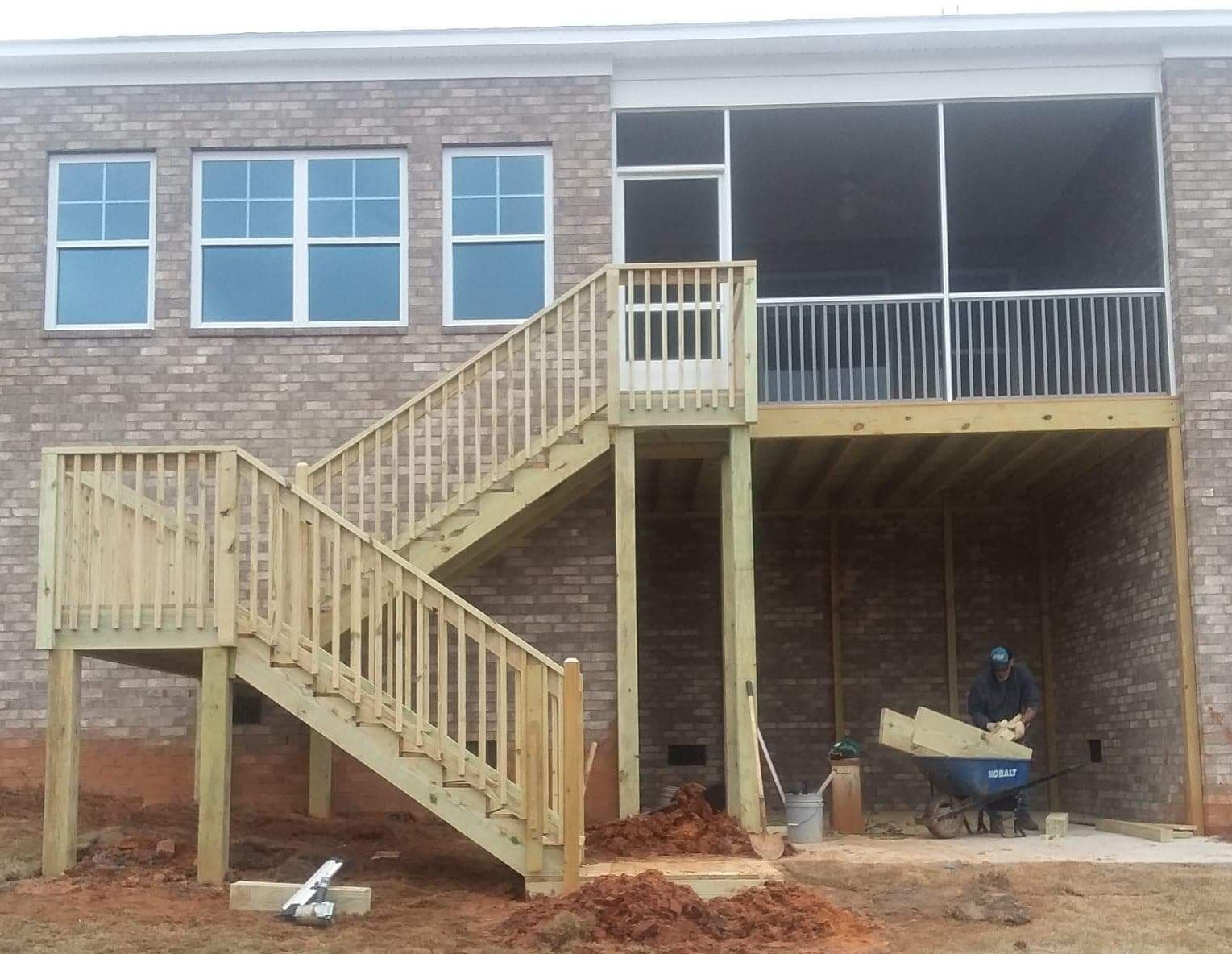 A house with a screened in porch and stairs