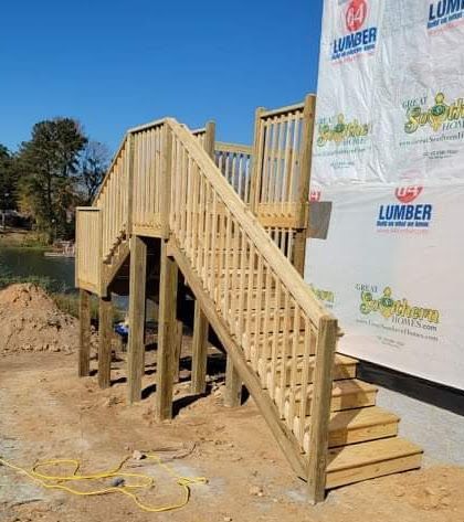 A wooden staircase is being built on top of a wooden deck.