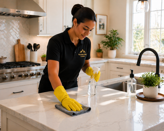 Yellow-gloved worker holding a black bucket with tools in a cleaning or maintenance setting