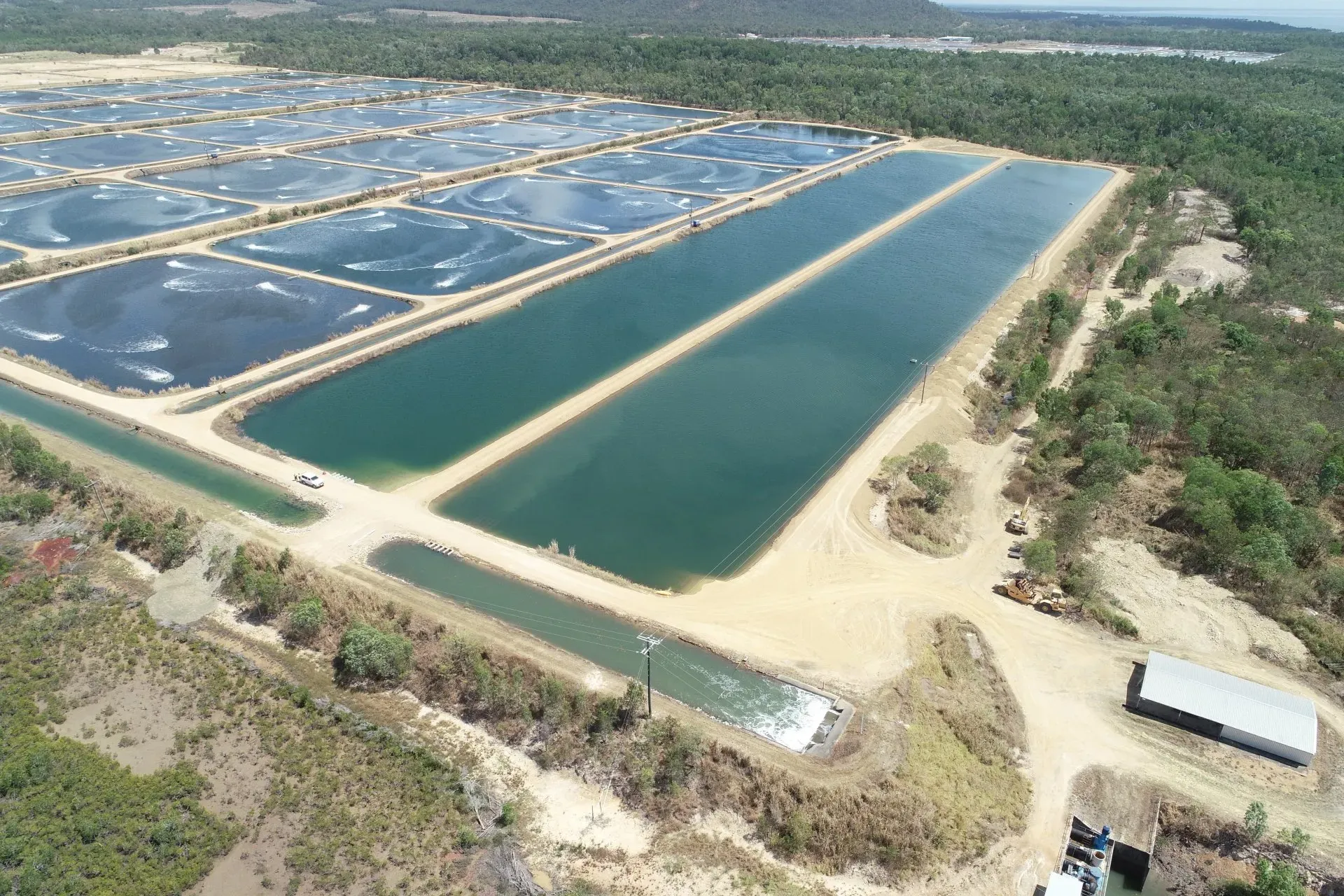 Side Aerial View of Crystal Bay Prawn Farm and a Car | Woree, Queensland | Cheshire Contractors