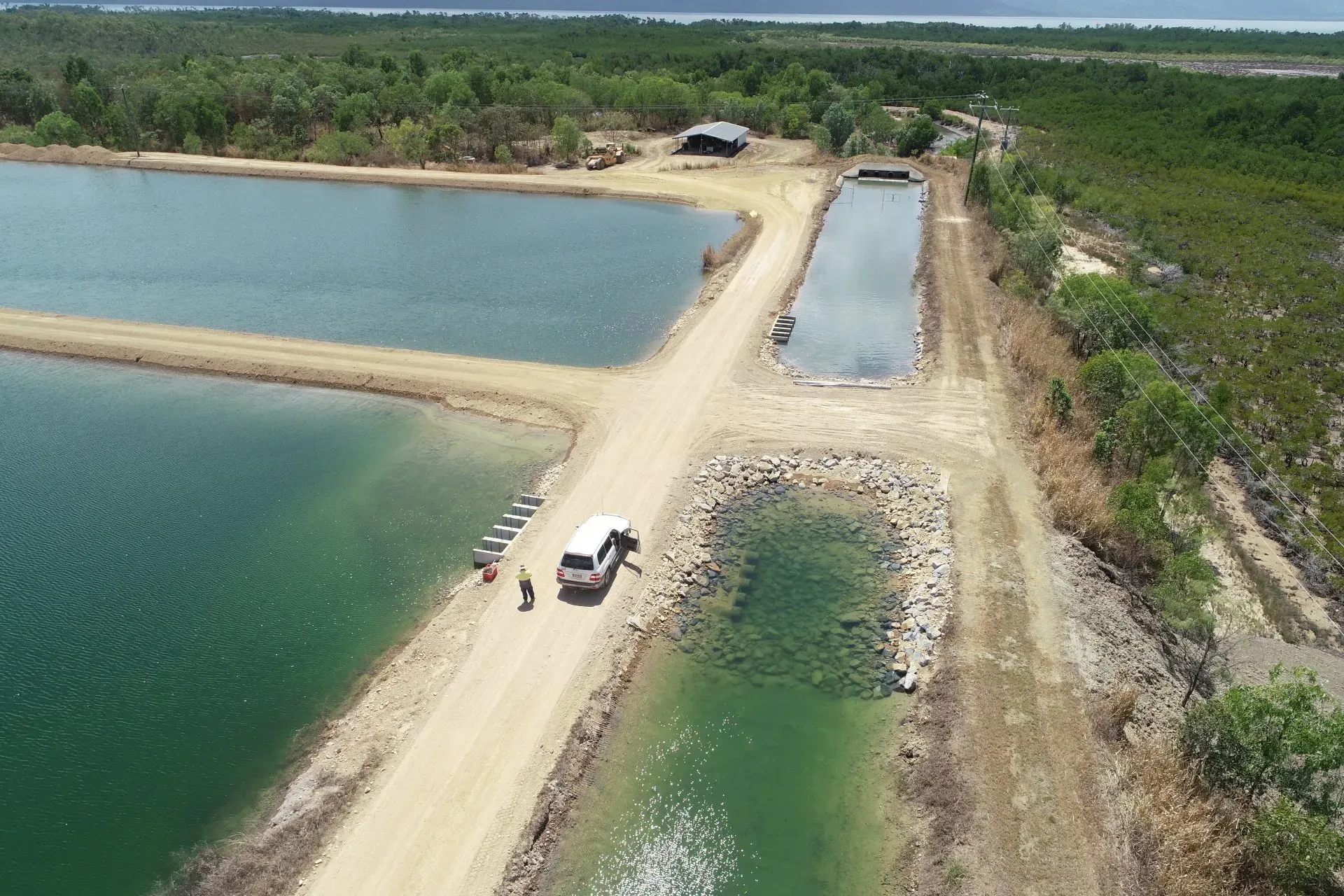 Side Aerial View of Crystal Bay Prawn Farm and a Car | Woree, Queensland | Cheshire Contractors