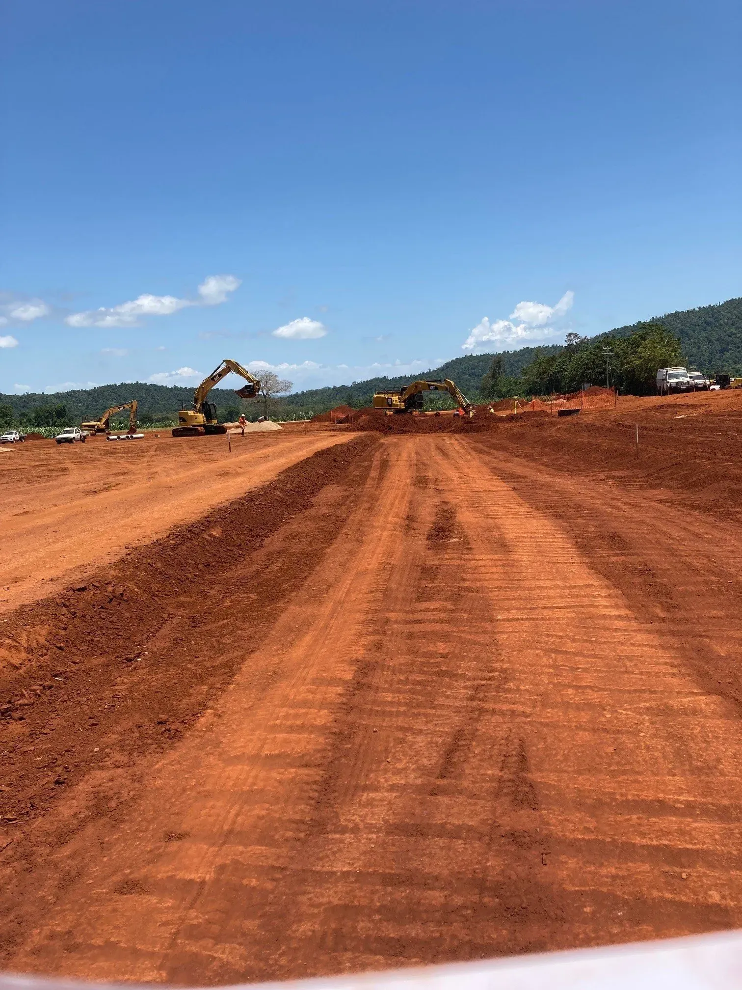 A Large Red Soil Field with an Excavator | Woree, Queensland | Cheshire Contractors