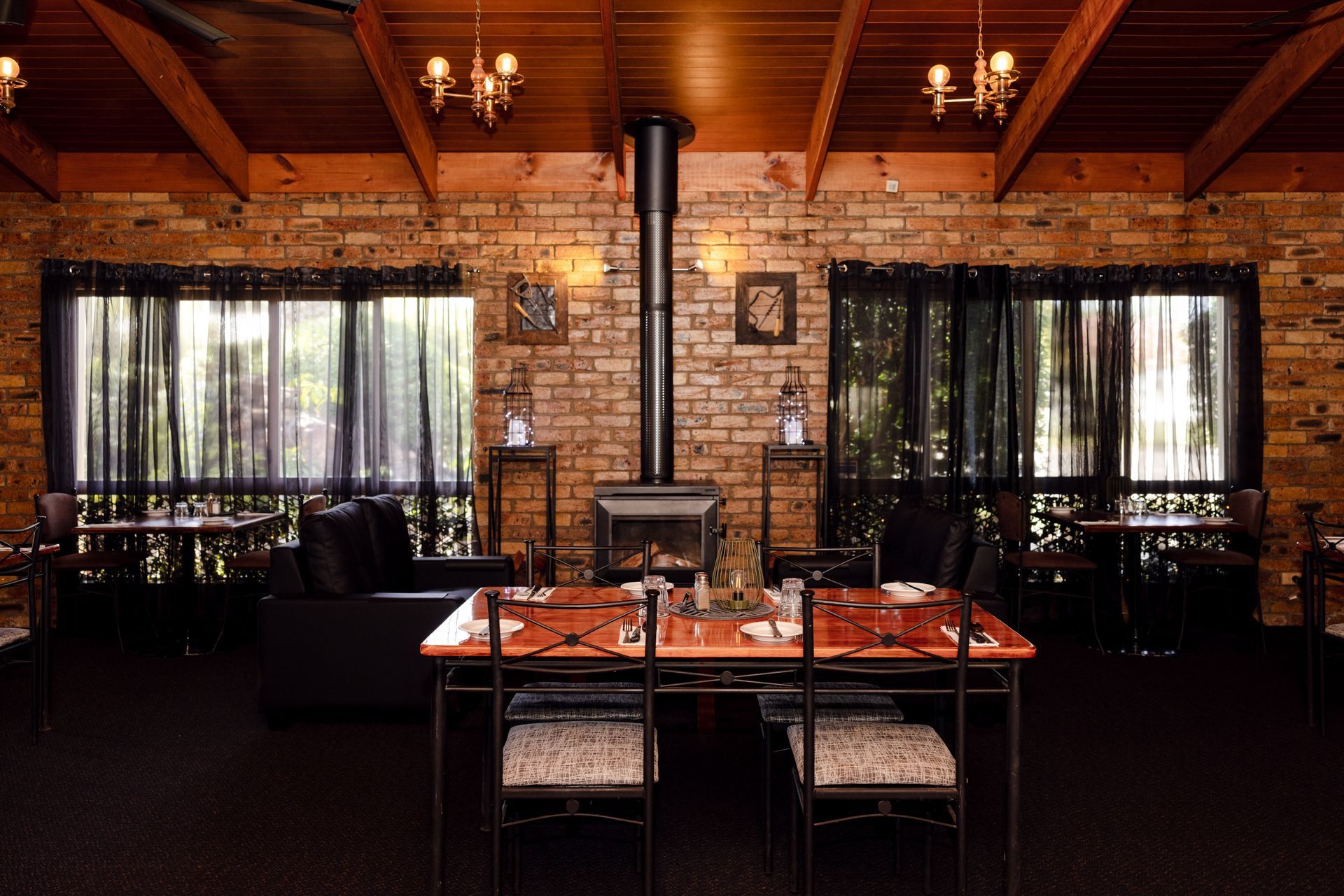A dining room with a table and chairs and a fireplace