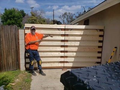 Metal Fence by Contractor Worker — Orange County, CA — Tom’s Handyman Fencing and Repair Service