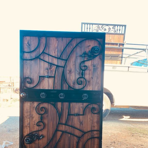 Wooden door with ornate black ironwork.