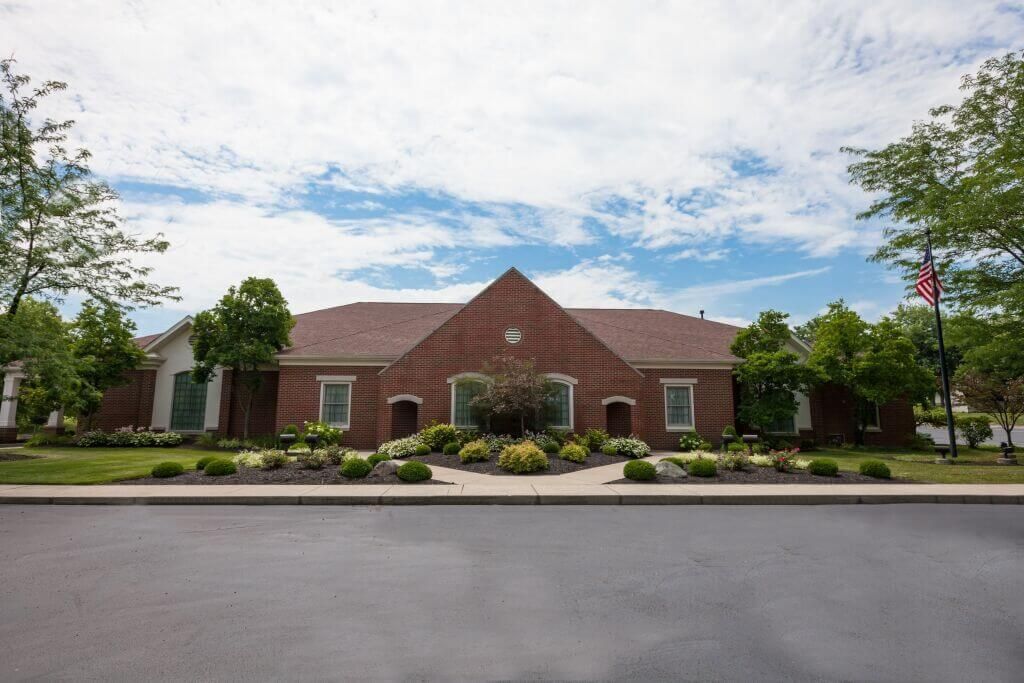 A large brick building with a red flag in front of it.