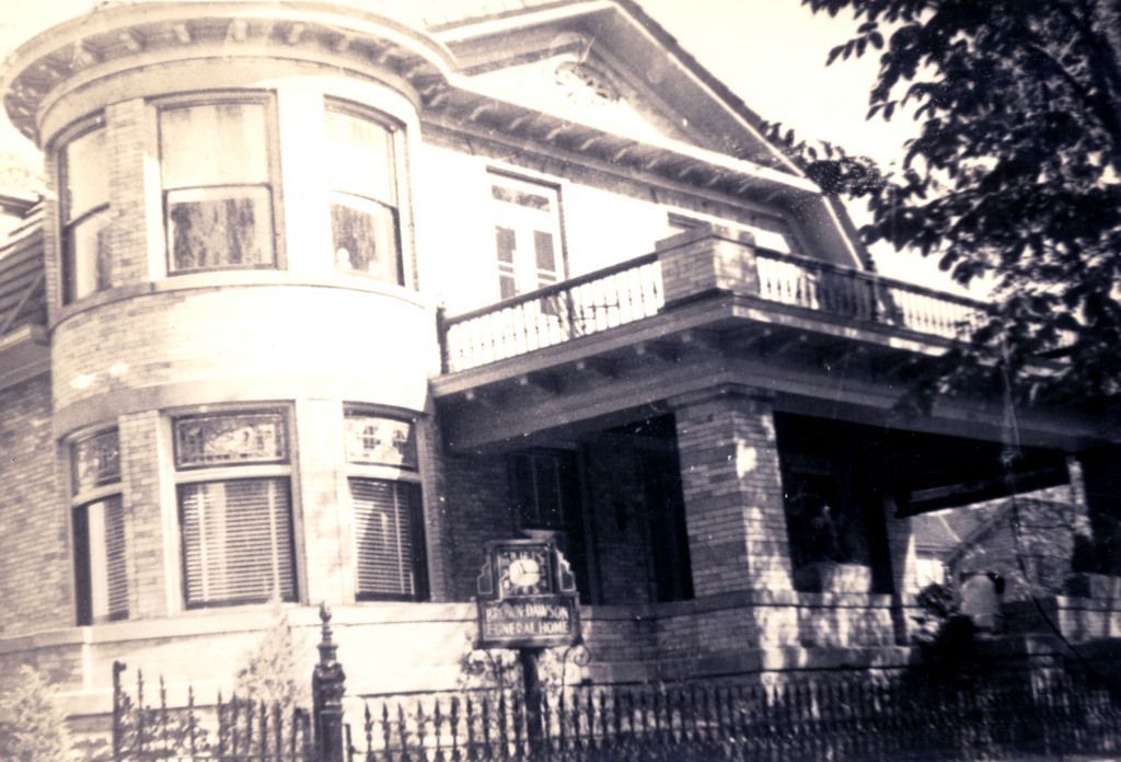 A black and white photo of a large brick house