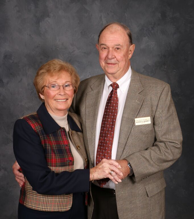 A man and a woman are posing for a picture together