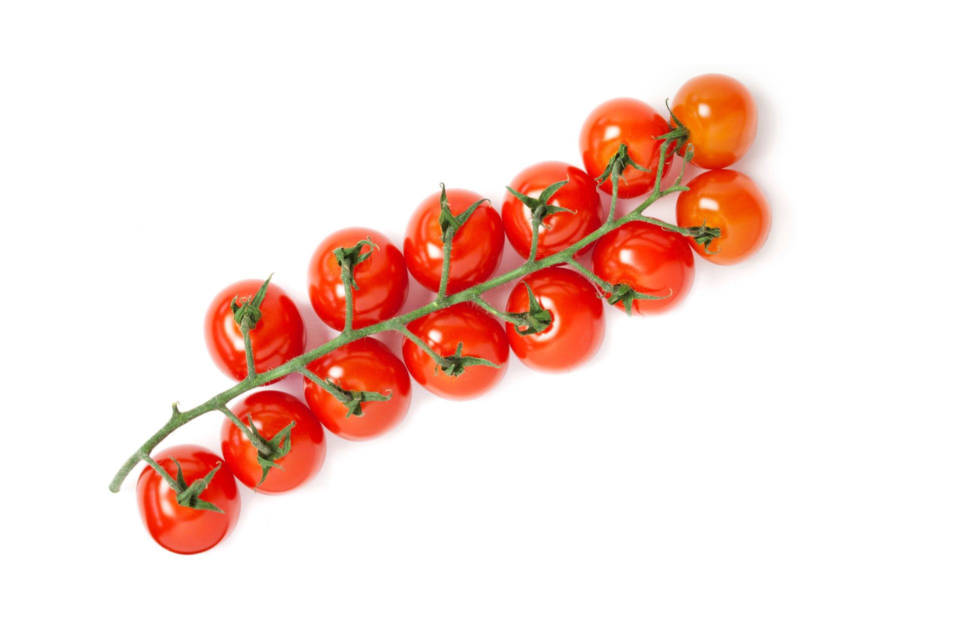 Cherry tomatoes with glossy red skins arranged in a group