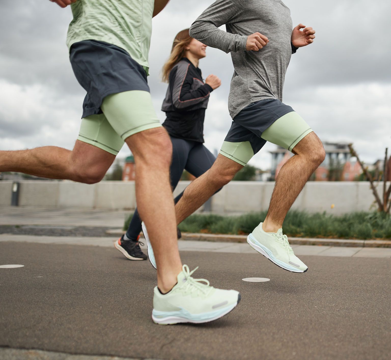 Three runners on a paved road