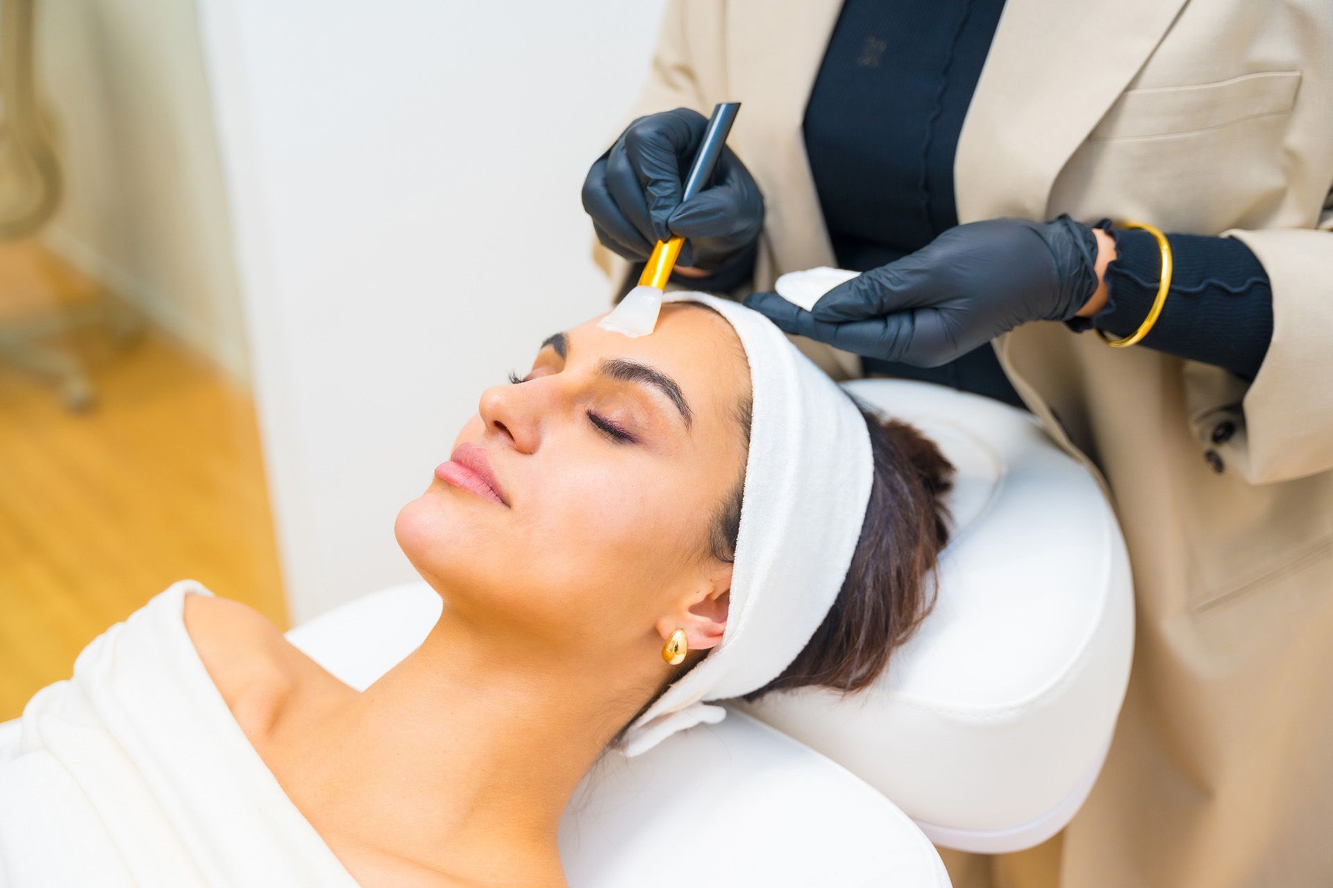 Woman receiving facial treatment