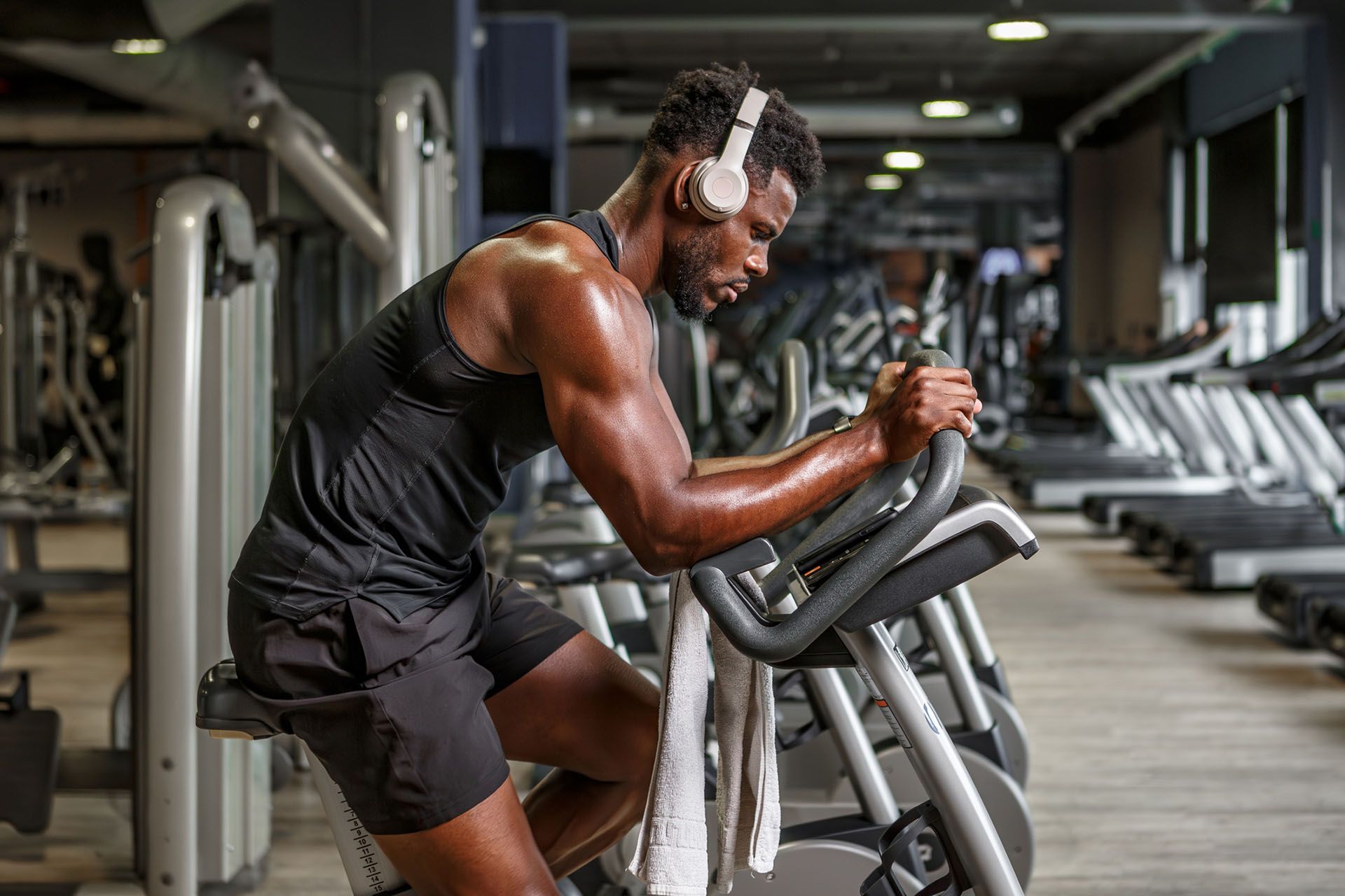 A man riding an exercise bike at the gym