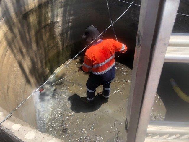 Man Cleaning Septic Tank — Waste Disposal in Gladstone, QLD
