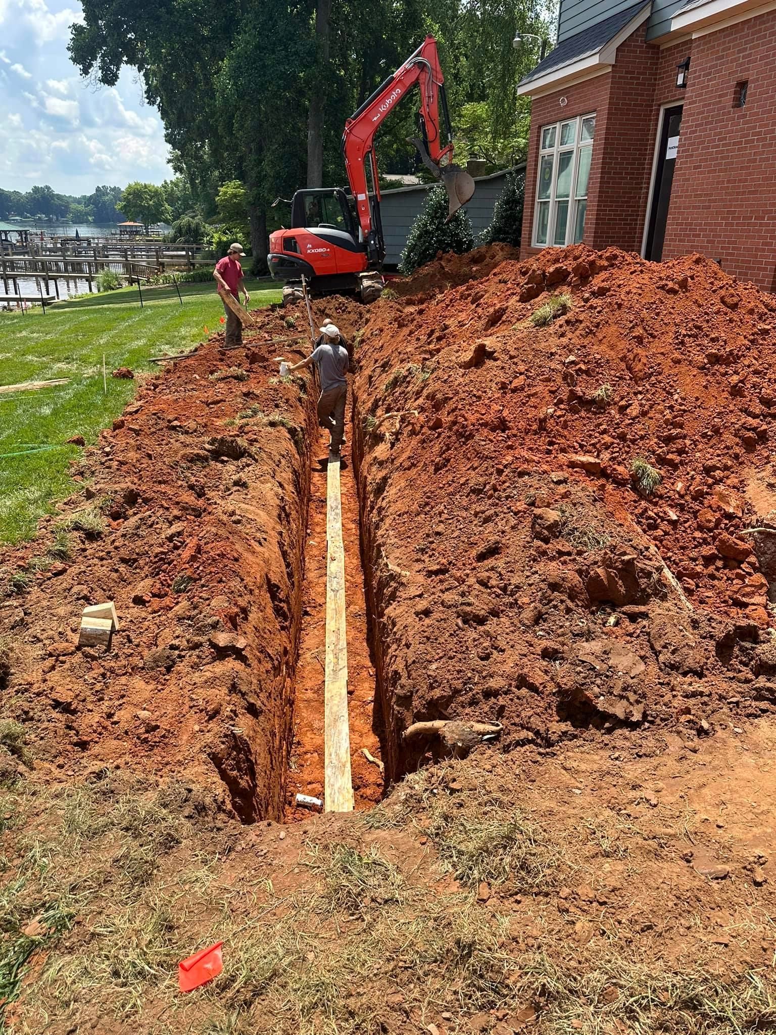 A septic tank is being installed in a trench.