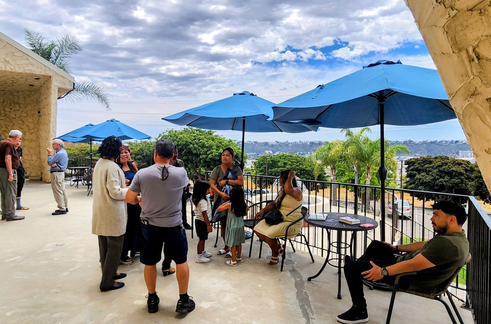 Two women looking at a pamphlet. One with blonde hair, the other with a bun. They're outdoors, likely sightseeing.