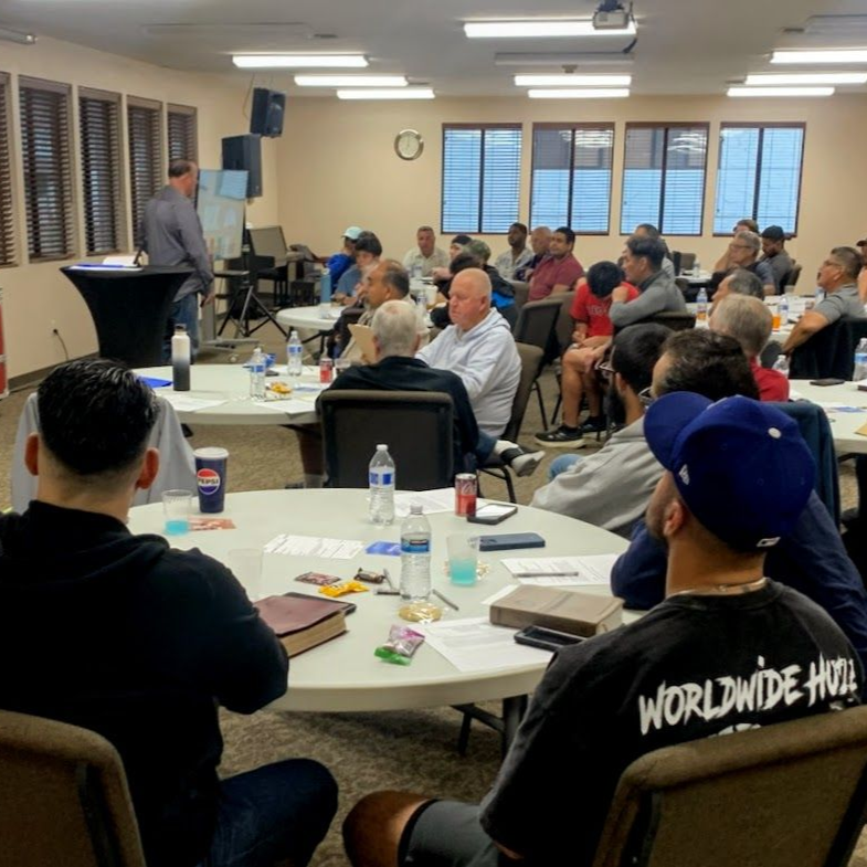 People with hands raised and eyes closed, worshiping and praying.